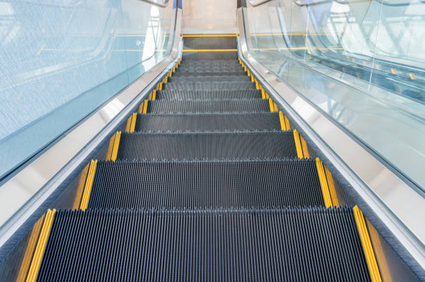 istock Escalator in shopping center 895868064