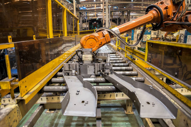 istock Robot arms handle tool keep automotive part to spot machine in car factory 895874310