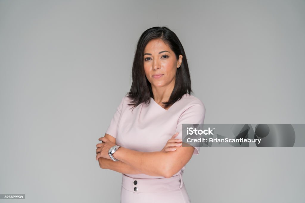 Professionally dressed wonam in pink Professionally dressed woman in pink of Hispanic ethnicity. Women Stock Photo