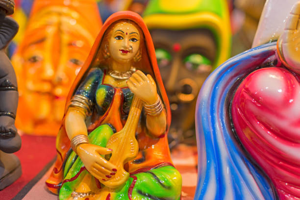 Woman singer with musical instrument, colorful dolls made of clay, handicrafts on display during the Handicraft Fair in Kolkata , earlier Calcutta, West Bengal, India.