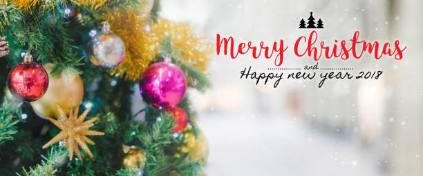 istock Christmas and Happy new year 2018 on blurred bokeh Christmas tree with snowfall background. 895910488