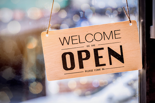 Wooden sign board hanging on door of cafe