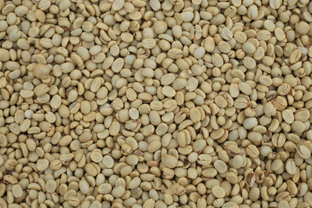istock Un-roast arabica raw coffee beans close up 895936244