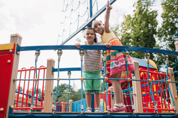 istock Little fidget children get fun in the park 895936538