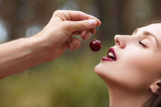 istock Woman Being Fed a Cherry 895938764