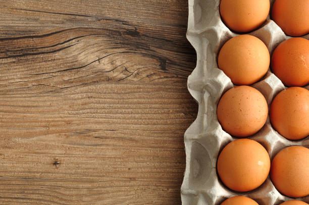 istock Eggs displayed in a carton on a wooden table 895957312