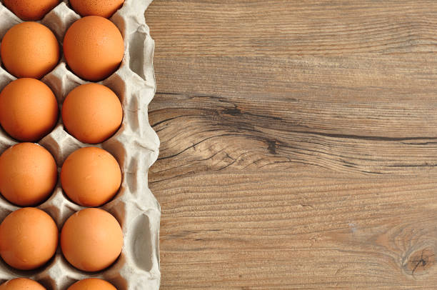 istock Eggs displayed in a carton on a wooden table 895957538