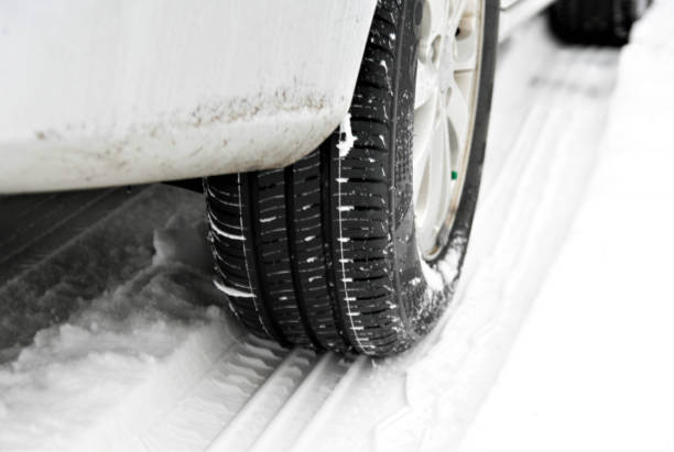 istock Car tires on winter road covered with snow 895972304