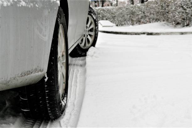 istock Car tires on winter road covered with snow 895972308