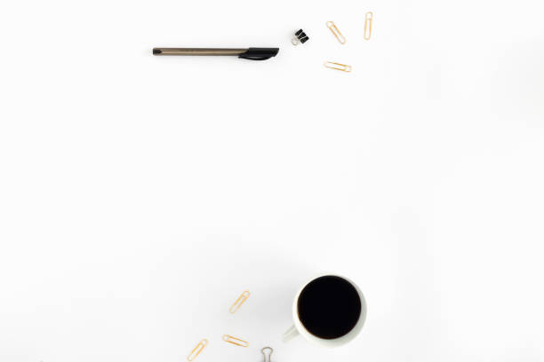 istock Workspace pattern with cup of coffee, pen and golden clips on white background. flat lay, top view 895972594