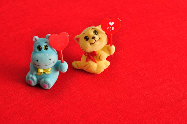 istock Valentine's day. Two figurines holding hearts 895985110