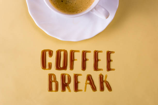 istock Coffee break. Letters of spilled coffee and a cup 895988806
