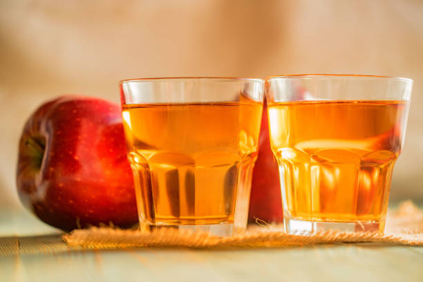 istock Fresh apple juice or cider in glasses on table 895993754