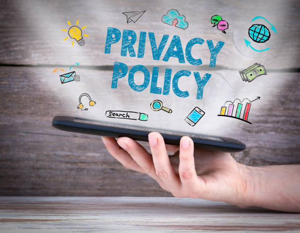 istock privacy policy. Tablet computer in the hand. Old wooden background 895996736