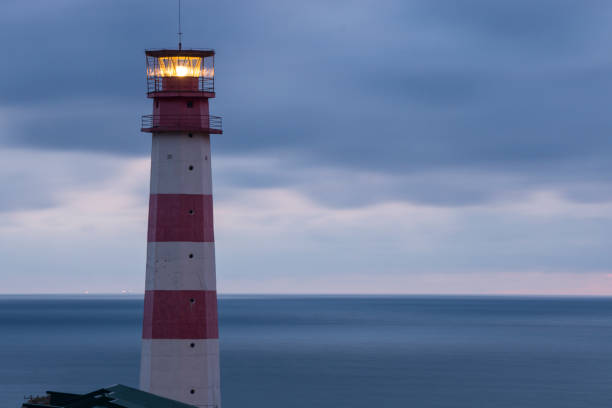 istock Lighthouse searchlight beam through marine air 895997084