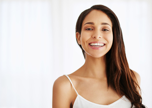 Portrait of a happy and beautiful young woman indoors