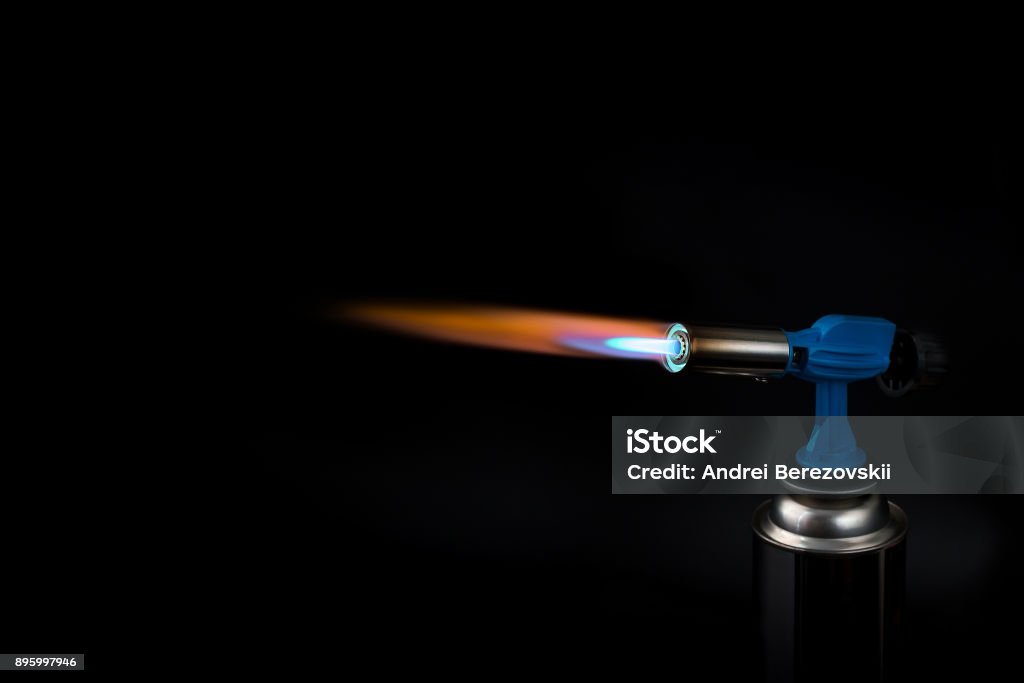 flame of a gas burner on a black background flame from a household gas burner with a ballon on a black background Flaming Torch Stock Photo