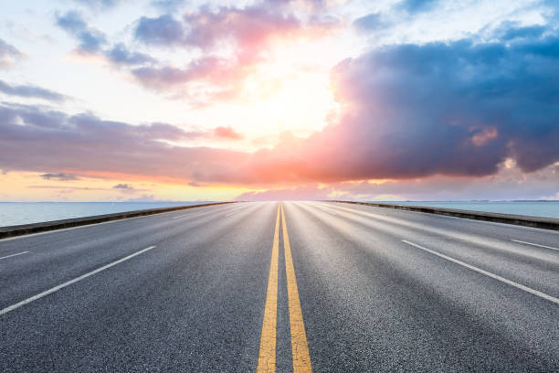 istock empty asphalt road and blue sea nature landscape at sunset 896000010