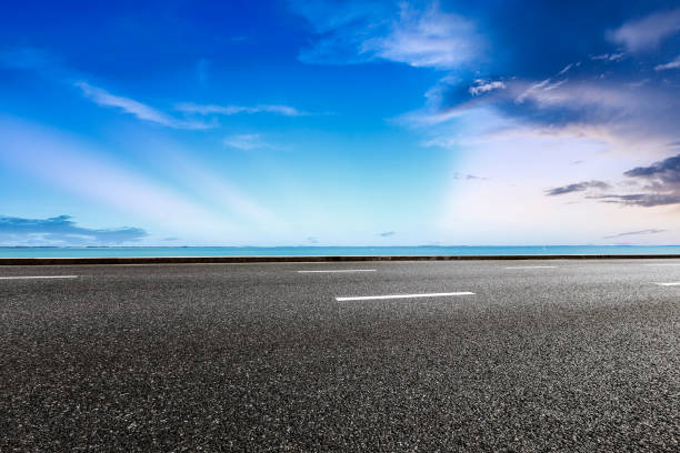 istock empty asphalt road and blue sea nature landscape at sunset 896000160