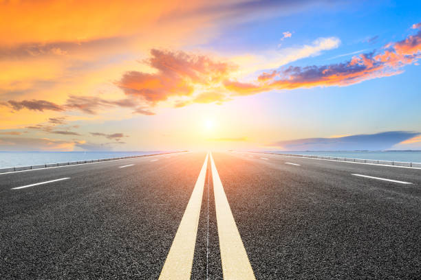 istock empty asphalt road and blue sea nature landscape at sunset 896000560