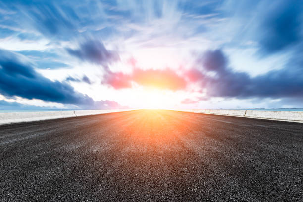 istock empty asphalt road and blue sea nature landscape at sunset 896003052