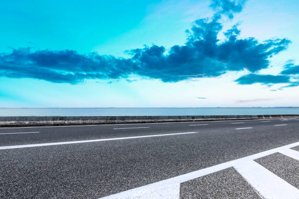 istock empty asphalt road and blue sea nature landscape at sunset 896003698