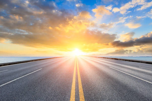 istock empty asphalt road and blue sea nature landscape at sunset 896008276
