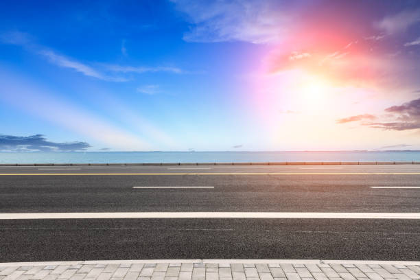 istock empty asphalt road and blue sea nature landscape at sunset 896008614