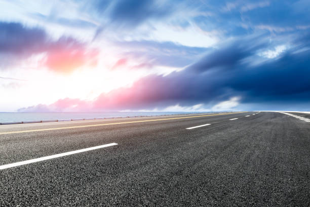 istock empty asphalt road and blue sea nature landscape at sunset 896013382