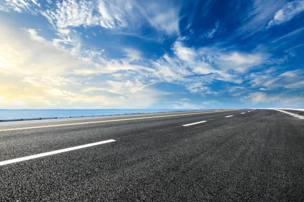 istock empty asphalt road and blue sea nature landscape at sunset 896016486