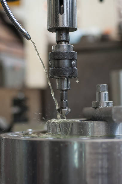istock Industrial drill bit machine cooled with water to prevent overheating 896028518