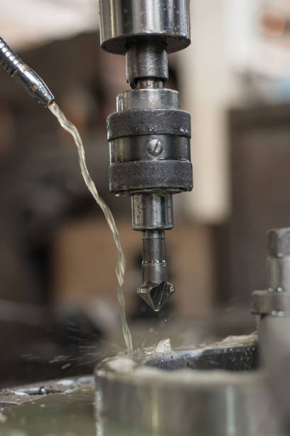 istock Industrial drill bit machine cooled with water to prevent overheating 896028592