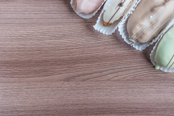 french eclairs on wooden table