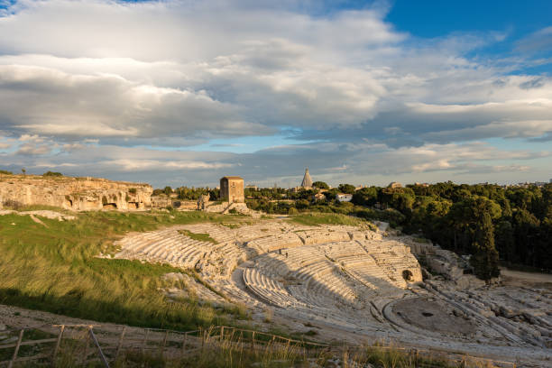 Greek Roman Theater in Syracuse - Sicily Italy Ancient Greek Roman theater at sunset in Syracuse city (Siracusa), Sicily island, Italy (V century BC) greek amphitheater stock pictures, royalty-free photos & images