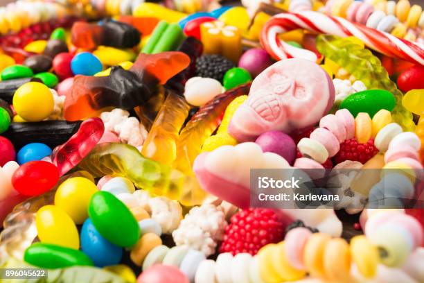 Different Candies With Closeup Pink Skull For Trick Or Treat Stock Photo - Download Image Now