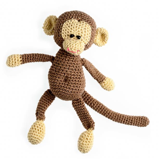 amigurumi crocheted monkey toy isolated on white background amigurumi crocheted monkey toy isolated on white background doll photos stock pictures, royalty-free photos & images