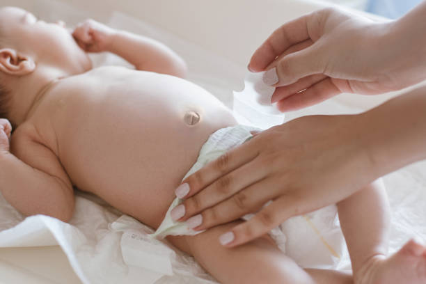 istock mother changes diapers to her newborn baby 896049448