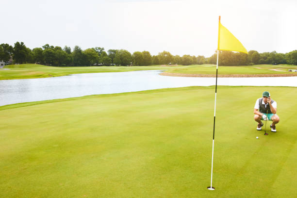 Shot of a young man out playing golf on the golf course