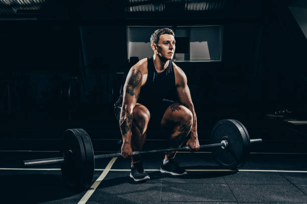 istock sportsman lifting barbell 896053012
