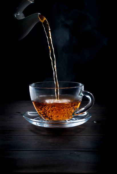 istock Cup of  tea on black   background 896059028
