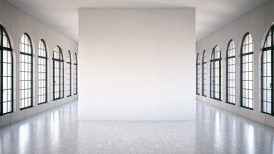 White interior with windows and a blank wall