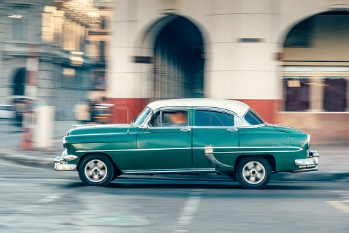 Old American car speeding at a street of Havana, Cuba