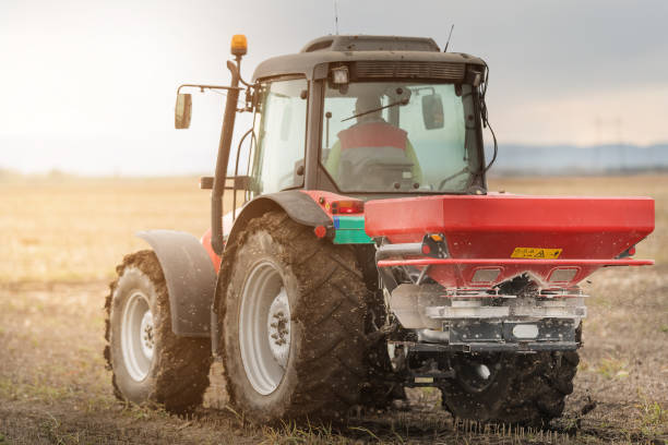 istock Tractor spreading artificial fertilizers  in field 896062146