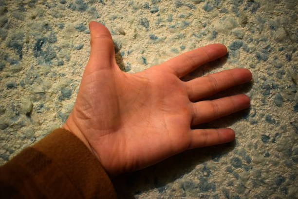 istock Brush your left hand against the wall in liquid wallpaper. 896065264