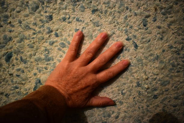 istock Brush your left hand against the wall in liquid wallpaper. 896065728