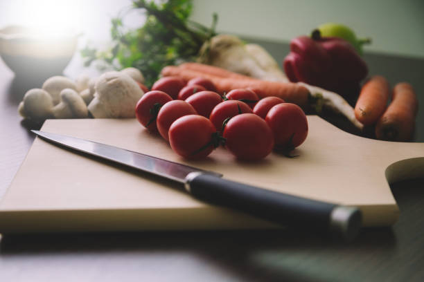 istock Fresh cheery tomatoes on wooden cutting board. 896076714