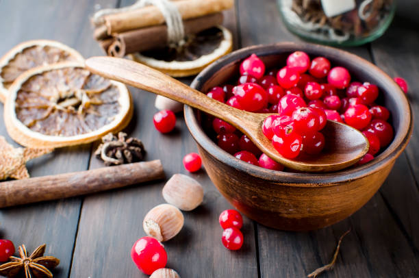 istock juicy cranberries in a plate and spice on wood table 896077144