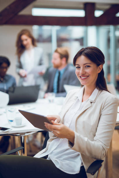istock Young businesswoman using digital tablet and analyzing business report. 896077334