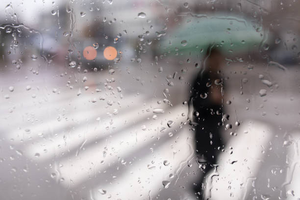 istock Young man with an umbrella hurries home 896092792
