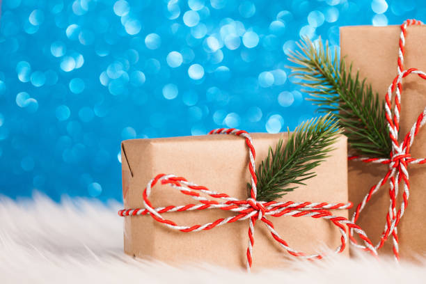 istock Christmas kraft gift on blue background 896093164